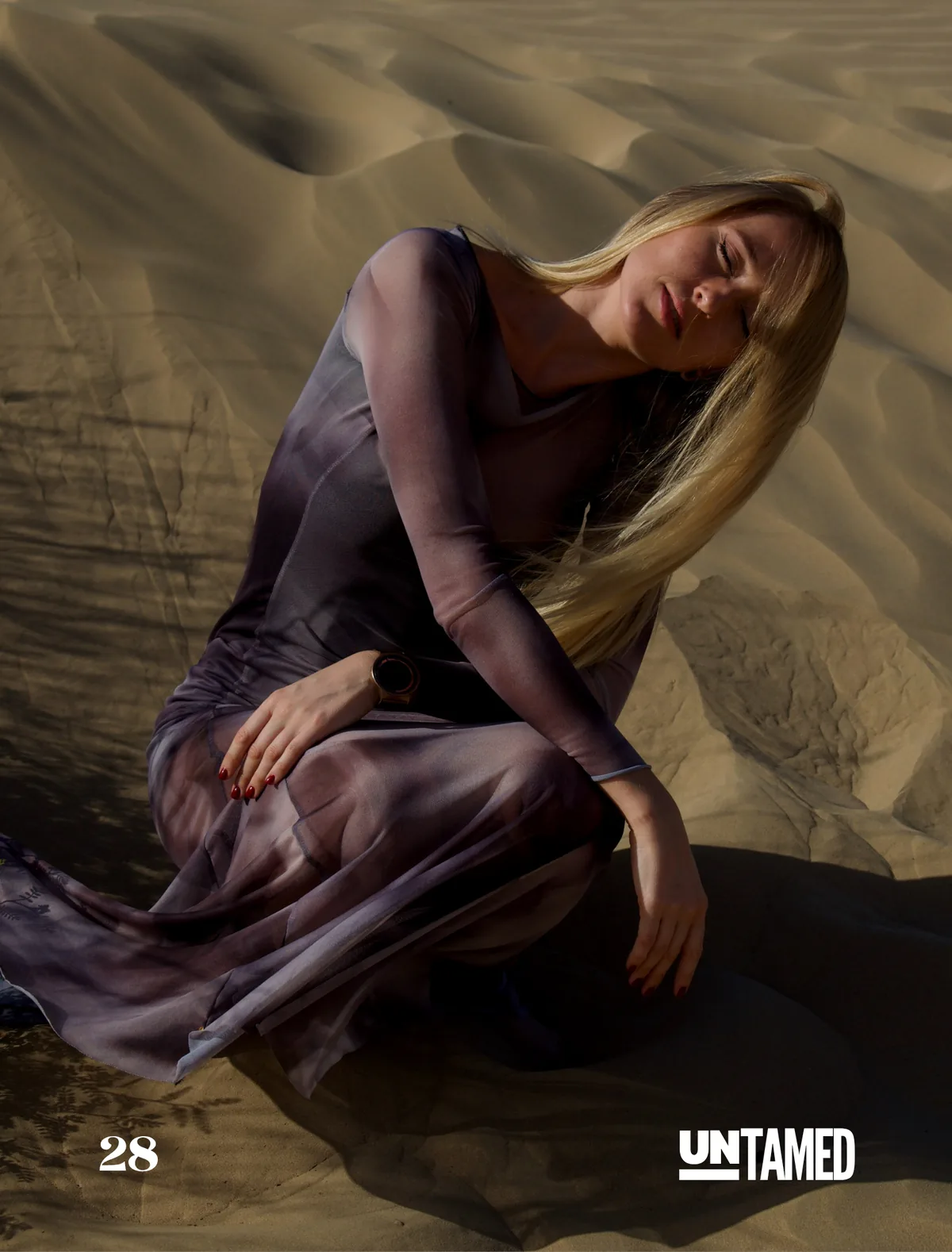 Model Olga kneeling on a dune at Al Qudra, UNTAMED Magazine editorial by Photoczaro